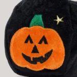 Close-up of the embroidered jack-o-lantern face on the black Halloween bag