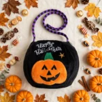 Flat lay of the black pumpkin Halloween bag with decorations