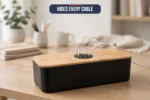 Angled view of the cable management box with cables routed through the bamboo lid