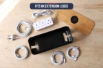 Flat lay of the cable management box with lid, power strip and routed cables