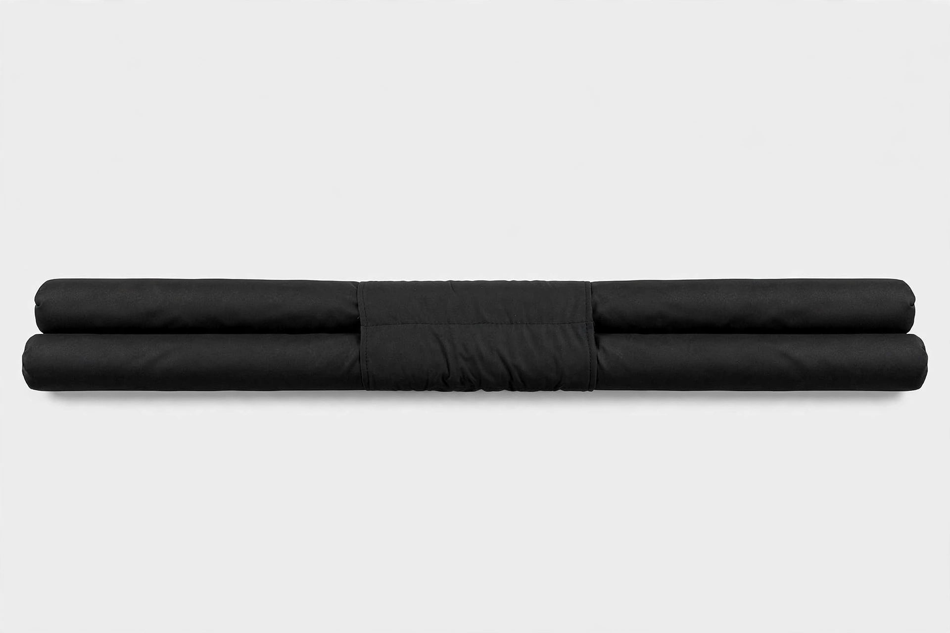 Twin tube door draught excluder under a white interior door, front view