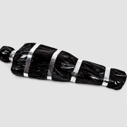 Scary fake corpse in black bag Halloween prop, front view