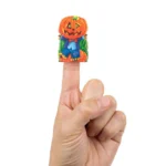 Halloween finger puppet worn on a finger showing scale