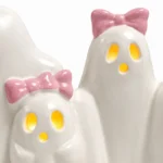 Close-up of the ghost faces showing glowing eyes and pink bow detail