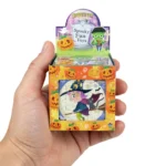Hand holding a Halloween mini jigsaw puzzle showing its pocket size