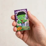 Hand holding a Halloween mini notebook showing pocket-size scale