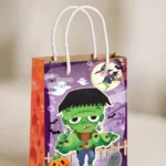 Close-up of the twisted handles and Frankenstein print on the Halloween paper party bag