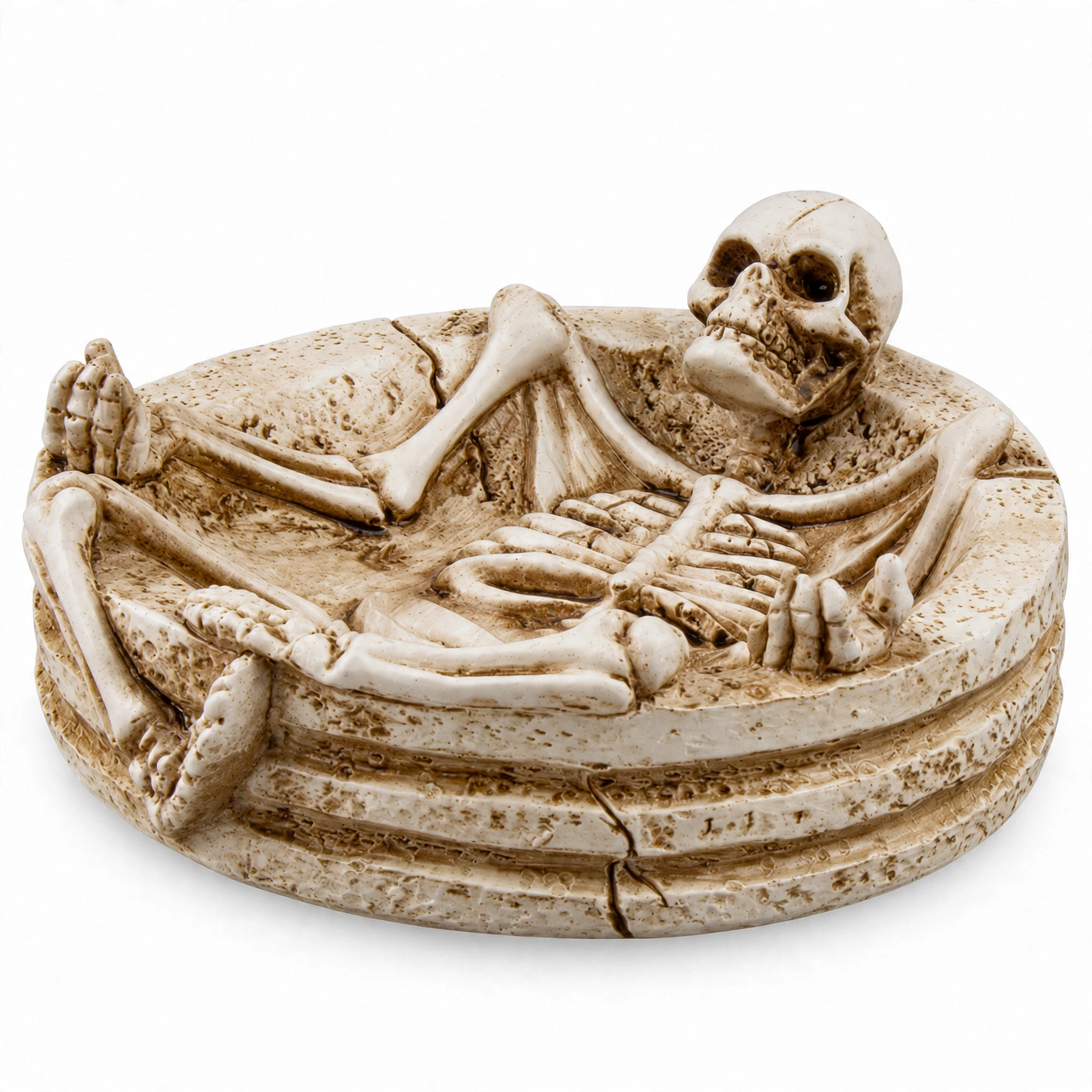 Halloween Skeleton Ashtray Front View Resin skeleton ashtray with full skeleton lounging in a stone dish, front view