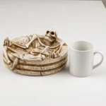 Skeleton ashtray shown to scale next to a standard mug