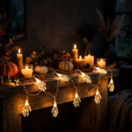 Skeleton hand LED string lights draped over a mantelpiece with Halloween decorations