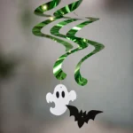 Close-up of the ghost and bat cutouts on the Halloween spiral decorations