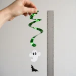 Hand holding a Halloween spiral decoration to show its 46cm length