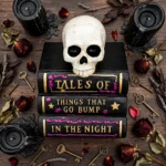 Flat lay of the stacked Halloween spell books with skull, candles and dark accents