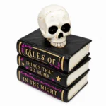 Three stacked black Halloween spell books with gold lettering and white skull on top, front view