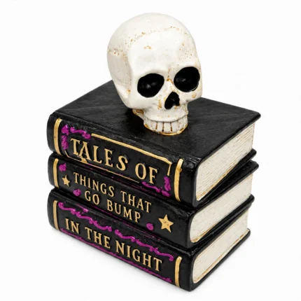 Three stacked black Halloween spell books with gold lettering and white skull on top, front view