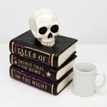 Stacked Halloween books with skull shown to scale next to a standard mug