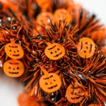 Close-up of the jack-o'-lantern pumpkin cut-outs on the Halloween tinsel wreath