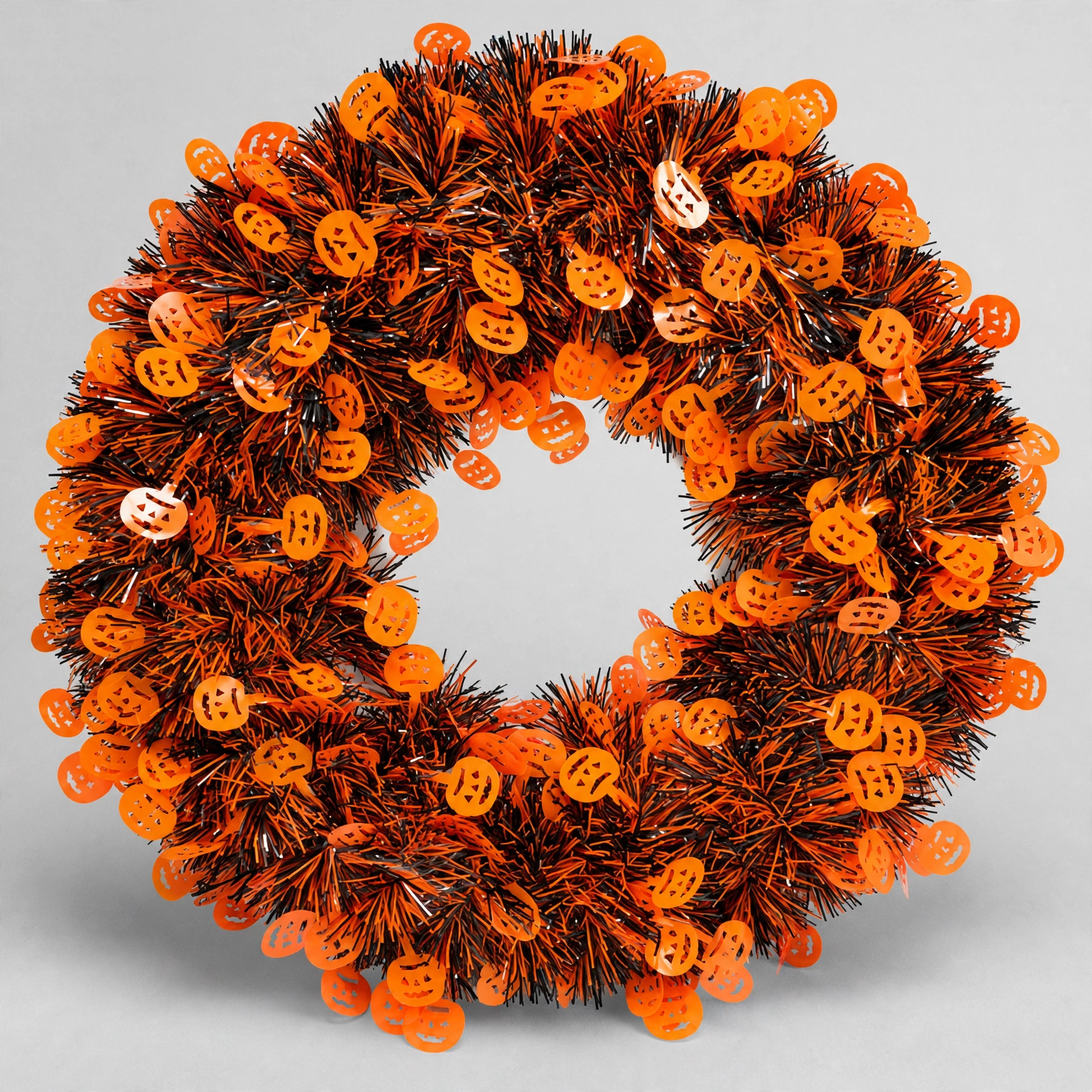 Halloween Pumpkin Tinsel Door Wreath Front View Orange and black Halloween tinsel door wreath with pumpkin cut-outs, front view