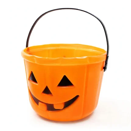 Orange pumpkin Halloween candy bucket with wire handle, three-quarter angle view