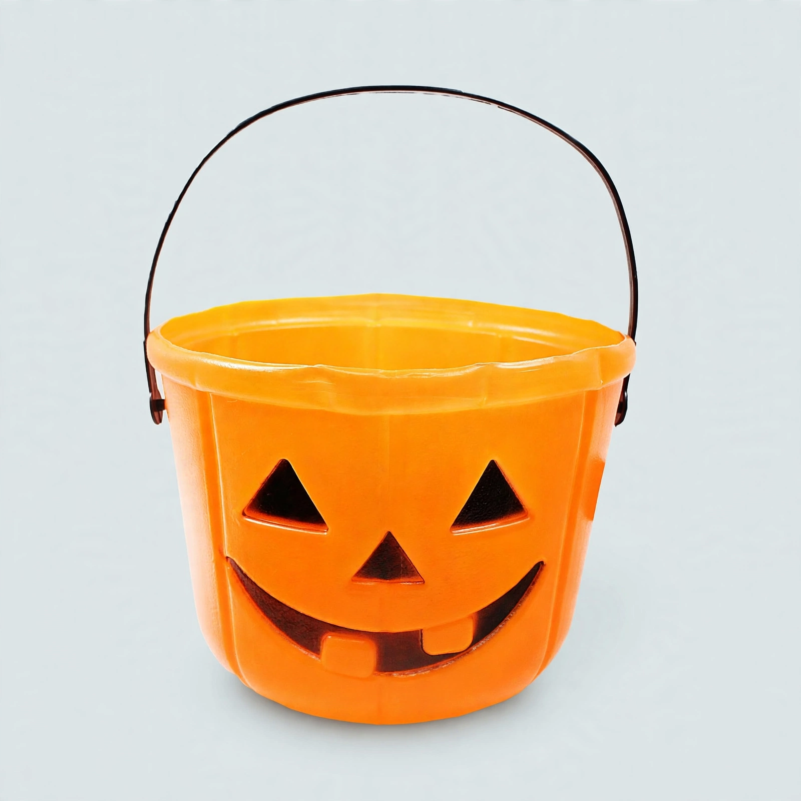 Kids Orange Halloween Trick or Treat Bucket Front View Orange Halloween trick or treat bucket for kids with printed pumpkin face, front view