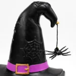 Close-up of the spiderweb etching and dangling spider on the witch hat