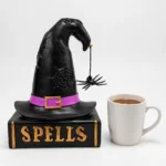 Witch hat spell book figurine shown to scale next to a standard mug