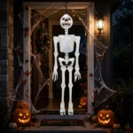 Giant inflatable Halloween skeleton hanging in a decorated doorway