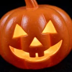 Close-up of the glowing jack-o'-lantern face on the Halloween pumpkin
