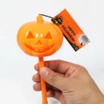 Hand holding the light up Halloween pumpkin showing its 13-15cm size