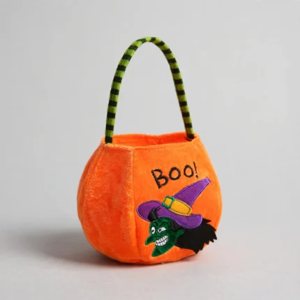 Orange Halloween candy bag with striped handle, three-quarter angle