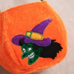 Close-up of the embroidered witch face on the orange Halloween bag