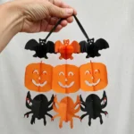 Hand holding the paper Halloween garland showing its scale