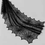 Black lace spider web cloth at an angle showing drape