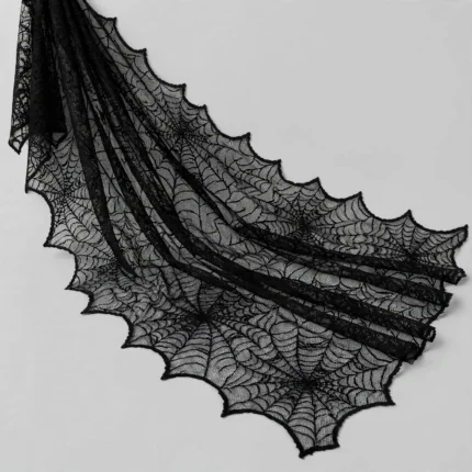 Black lace spider web cloth at an angle showing drape