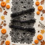 Flat lay of the spider web table runner with Halloween props