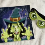 Close-up of the witch poster and self-adhesive green noses