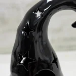 Close-up of the star cut-outs on the ceramic witch hat
