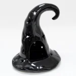 Black ceramic witch hat tealight candle holder with star cut-outs, front view